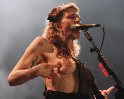 Courtney strips off and goes topless at Brazilian concert