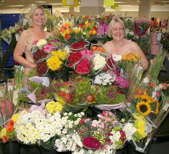  Blooming gorgeous! Two blonde members of staff preserve their modesty with bunches of flowers