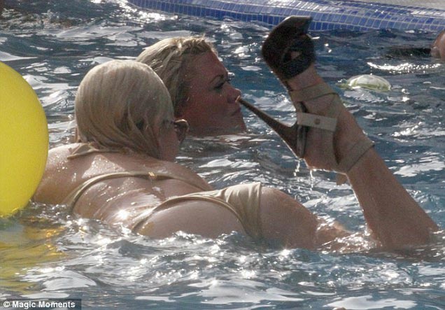 Lydia Bright dives into champagne pool party in tiny bikini and 6 inch heels