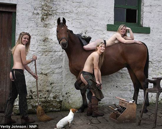 Women poses naked alongside horses and hounds