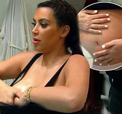 Kim Kardashian bares belly and rubs stretch-mark cream on baby bump