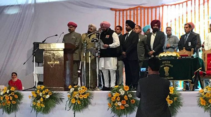 Capt Amarinder Singh takes oath as Punjab CM; Navjot Singh Sidhu touches feet, Modi tweets best wishes
