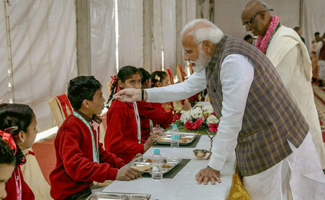 Modi says Cow is the centre of our tradition & culture, serves 3rd billionth meal at Vrindavan